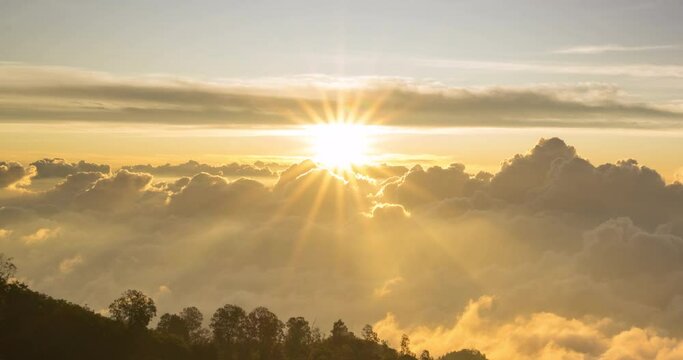 Timelapse of the sun setting over layers of rolling clouds on the mountain