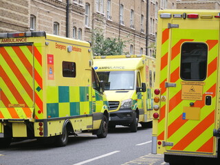 Several Emergency Ambulances Parked on a UK City Street - Major Incident - 999 - Blue Lights