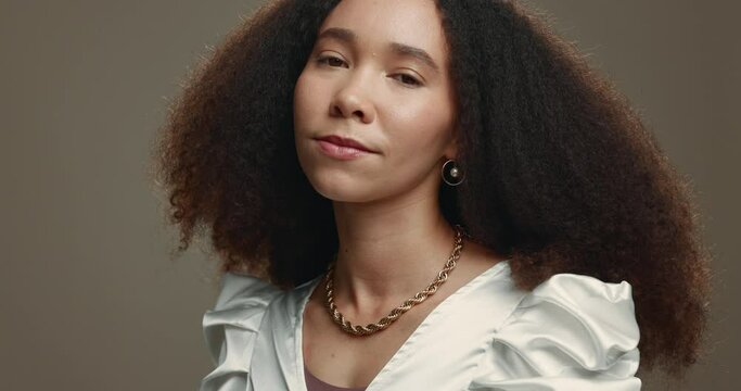Face, hair and natural with an afro woman in studio on a gray background for salon treatment. Portrait, spa and beauty with a confident young female model at the hairdresser for haircare or hairstyle