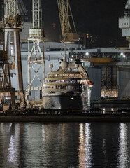 Italian shipbuilder dry dock ship building facilities in Palermo, Sicily Italy with massive construction cranes and docks and luxury cruiseship cruise ship liner maintenance modernisation overhaul ren