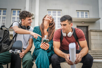 group of teenage students gen z sit outdoor use mobile phone smartphone