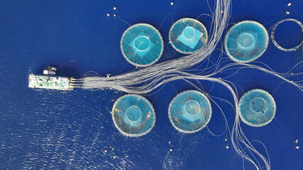 Aerial drone photo of latest technology fish farm breeding cages in fishery unit located in...