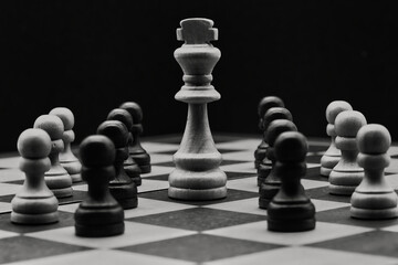 Chess pieces on a chessboard, black and white photo.