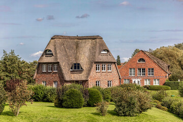 Fototapeta na wymiar Typical houses of northern germany, Schleswig-Holstein in summer