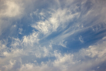 The image portrays a perfect blend of white clouds against the vivid blue sky, epitomizing a clear day with a touch of charm.