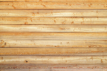 Texture of the yellow wall made of knotty sanded wooden boards as a retro natural background