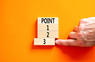 Time to point 3 symbol. Concept word Point 1 2 3 on wooden block. Businessman hand. Beautiful orange table orange background. Business planning and time to point 3 concept. Copy space.