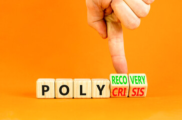 Polycrisis or polyrecovery symbol. Concept words Polycrisis Polyrecovery on wooden cubes. Beautiful orange background. Businessman hand. Business Polycrisis or polyrecovery concept. Copy space.