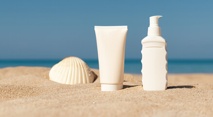 Fototapeta na wymiar unmarked cream jars on beach sand