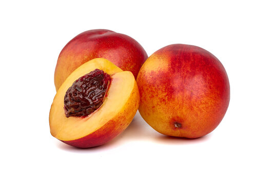 Fresh nectarines and juicy slice. Organic fruits, isolated on white background.