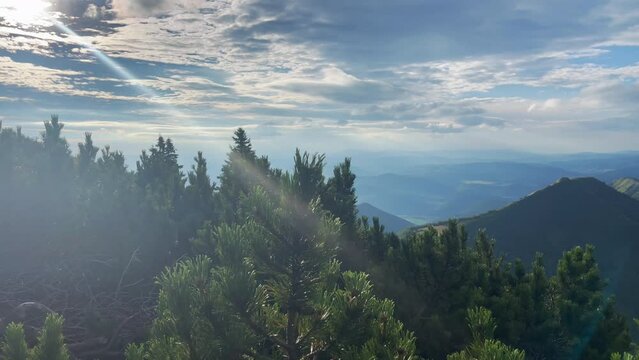 Picturesque landscape with unique sun ray barking through the clouds over the Mala Fatra mountain range, Zilina region, Slovakia. Beauty in Nature concept 4K footage.