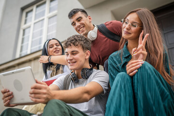 group of students sit in front of school video call on digital tablet