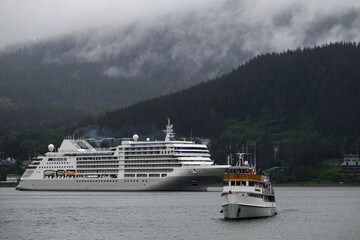 Luxury Silver cruiseship cruise ship liner Muse arrival into port of Juneau, Alaska during nature...