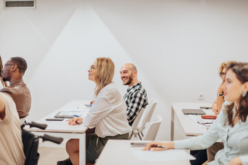 Blonde businesswoman at the seminar meeting with her colleagues