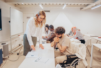 Business coach helping disabled male employee