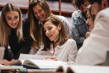 Female professor helping a group of students