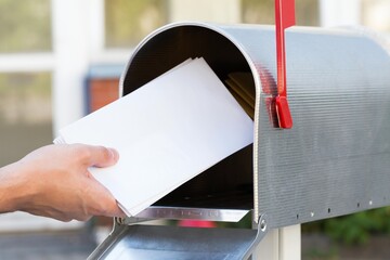 Person Putting Letters In Mailbox