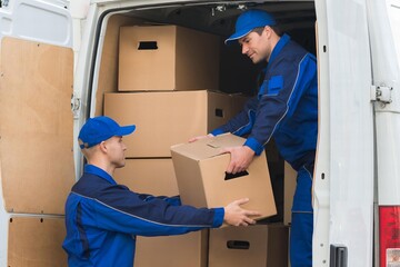 Delivery Men Unloading Boxes From Truck