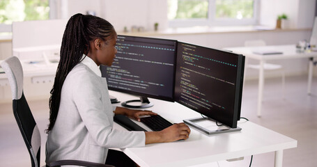 African American Coder Using Computer At Desk