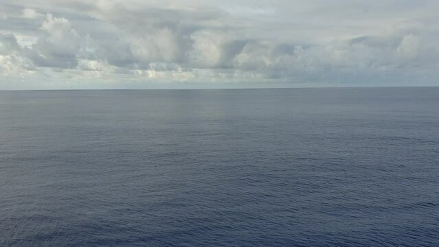 Blue sky with clouds in sunny weather over the ocean.