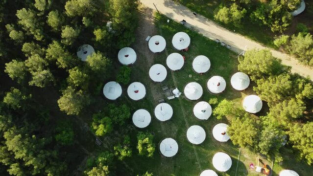 Aerial view of collective mongolian tents in the forest
