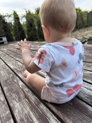 little child sitting on a bench
