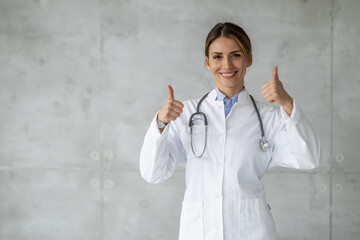 Portrait of female doctor on grey background