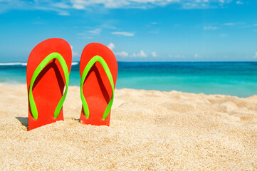 Fototapeta na wymiar Holidays Background. Beach sandals on the sandy coast, Thailand