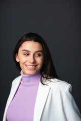 Fototapeta premium Portrait of young happy beautiful woman smiling and standing over gray background. Young female girl