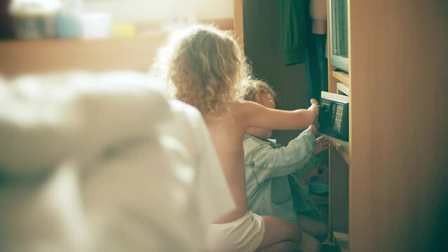 Little girls open and close a safe box