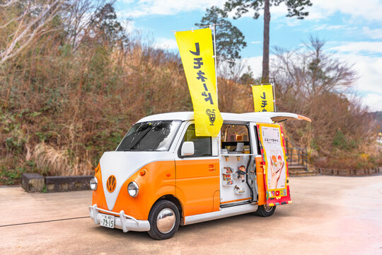 saitama, japan - march 16 2023: Cute orange and white food truck from the iconic brand Volkswagen famous for its combi split van from sixties featuring a mobile cafe dedicated to japanese lemonade.