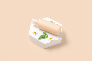Composition with plaster podium, bottle of cosmetic product and chamomile flowers on color background
