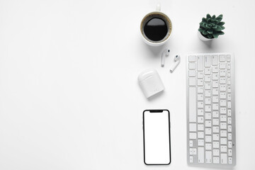 Composition with modern devices, cup of coffee and houseplant on white background