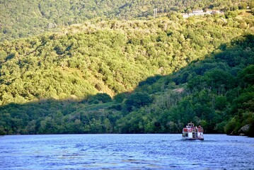 sailing on a ferry in the river canyon of Sil at sunset