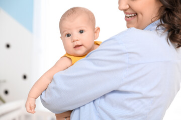 Young woman with her baby in bedroom, closeup