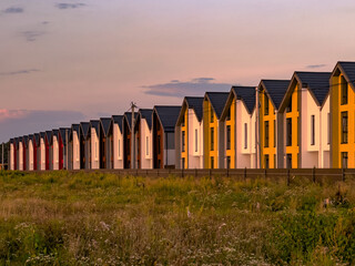 Newly built colorful townhouses built together as a single complex lined up in row in the suburbs...
