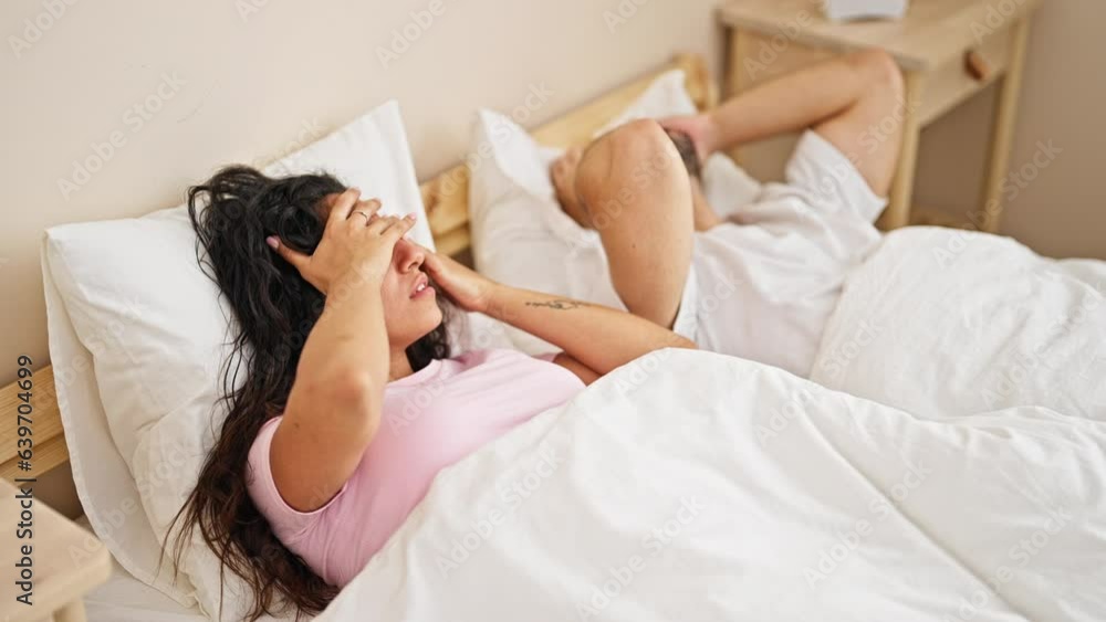 Sticker man and woman couple lying on bed covering ears for noise at bedroom