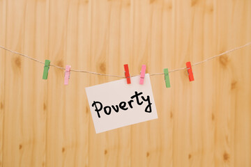 Poverty - card with text on clothespins about social issues and problems