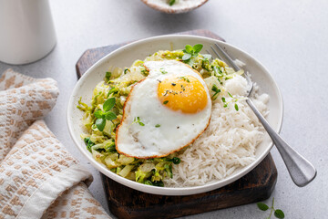Rice bowl with sauteed cabbage and fried egg, healthy lunch or breakfast idea
