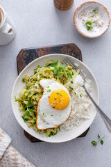 Rice bowl with sauteed cabbage and fried egg, healthy lunch or breakfast idea