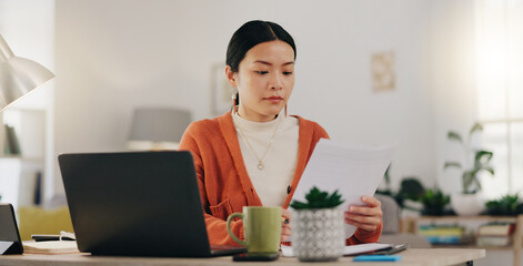 Fototapeta premium Remote work, paperwork and Asian businesswoman working on laptop from home, house or apartment. Freelance, worker and professional employee review report and planning company strategy on documents