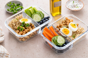Vegetarian lunch meal prep containers high protein with quinoa, herbed chickpeas, vegetables and eggs