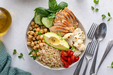 Healthy high protein lunch bowl with grilled chicken, roasted cauliflower, chickpeas and quinoa