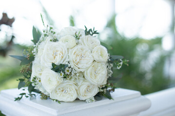 Beautiful bunch of white roses bouquet on white pedistal