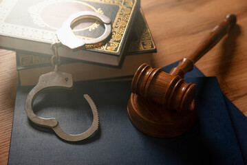 Handcuffs and wooden gavel. Crime concept.