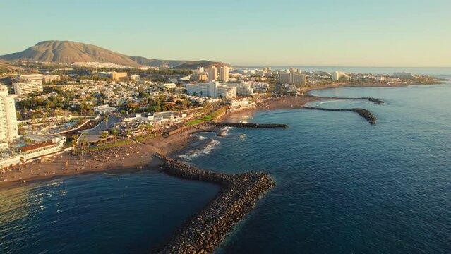 Flight over Costa Adeje resort town at sunset in Tenerife, Canary islands, Spain