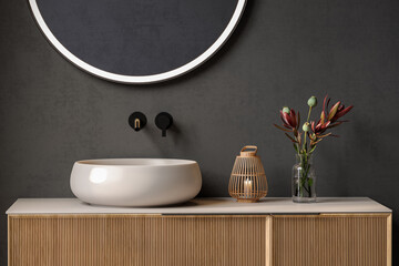 Close up chic bathroom with oval sink, empty countertop, wooden vanity, black-framed mirror, flower...