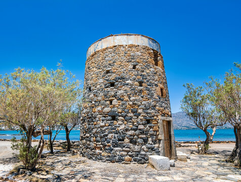Remains of an old, stone windmill on the Kolokitha peninsula near the town of Elounda, Crete