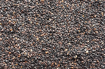 Background from black sesame seed, close-up, top view. Macro of roasted black sesame seeds.Organic food concept.