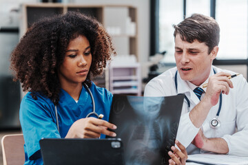 Medical staff team african american meeting discussing chest x-ray film Radiologists medical...